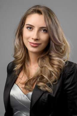 Portret business profesional femeie, fundal gri, ținută elegantă, fotografie corporate pentru profil LinkedIn sau website companie
